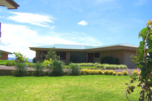 The hilltop community has broad lawns and pretty landscaping.